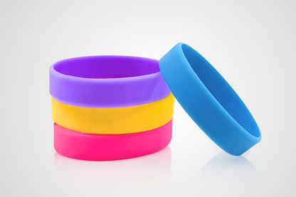 A stack of colored silicone wristbands for children without print